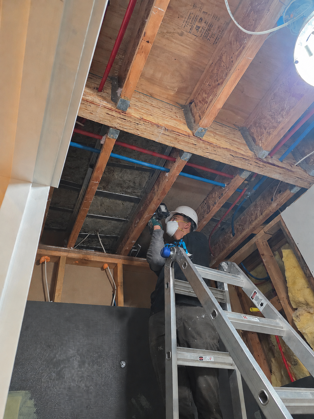 Le Bros Construction electrician installing wiring in a new DADU/ADU build in the Seattle area