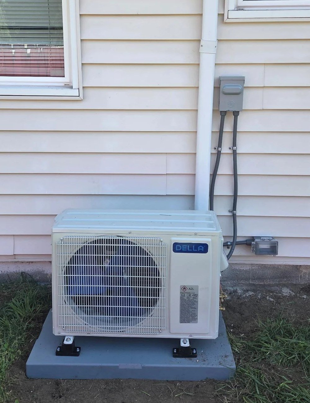 Outdoor condenser unit and refrigerant line set installed by Le Bros Construction electricians