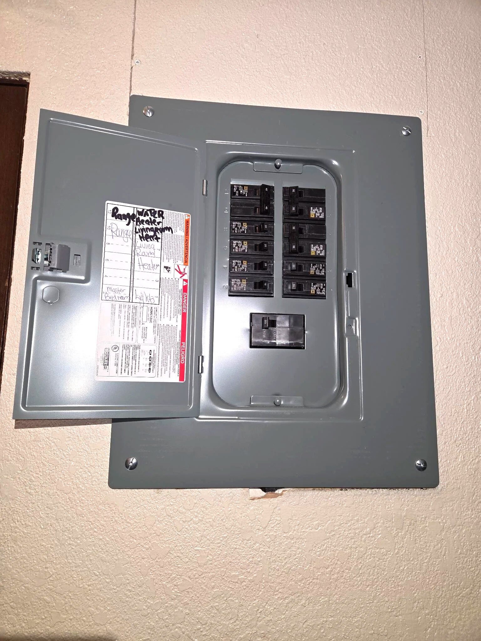 Finished apartment panel swap by Le Bros Construction — dead front cover installed with hand-labeled circuit directory