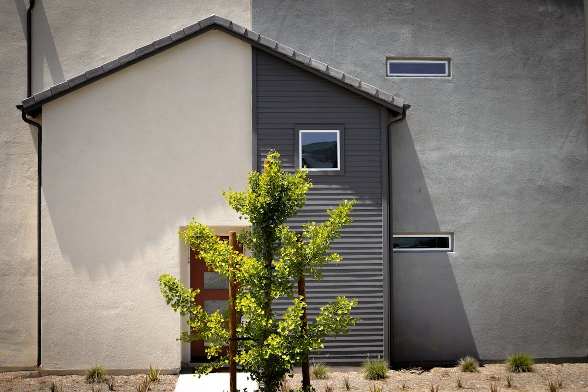 Modern DADU exterior with dark metal corrugated siding — Seattle-style detached accessory dwelling unit