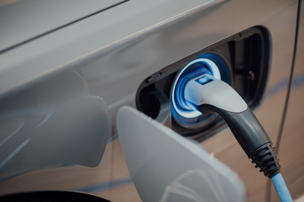Electric vehicle charger cable plugged into a car at home for Level 2 charging