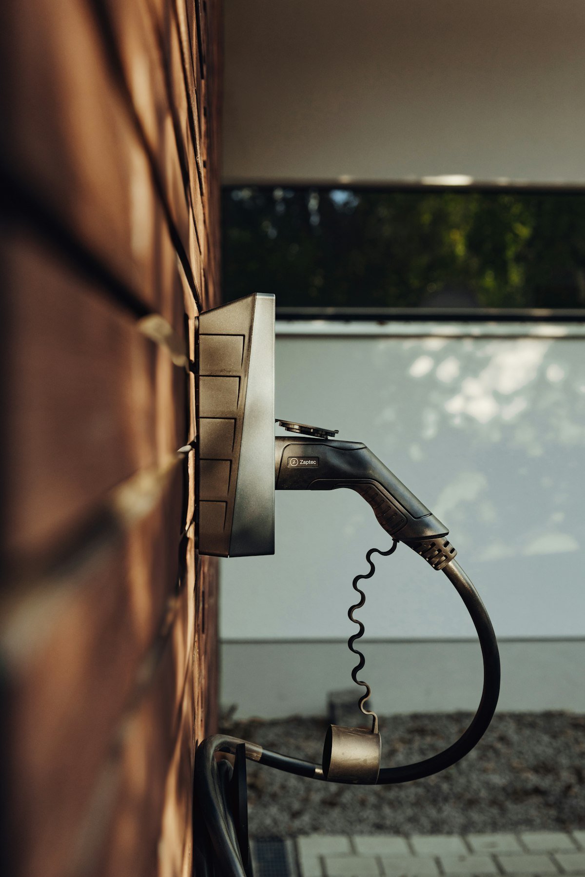 Wall-mounted Level 2 home EV charger unit installed in garage